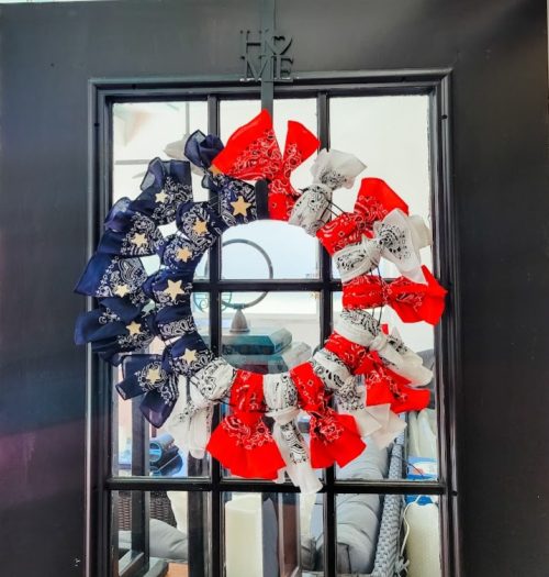red, white, and blue wreath made from bandanas on a black door get your home ready for summer