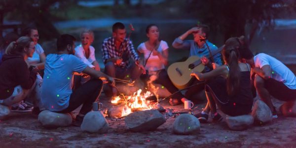 people sitting around a campfire