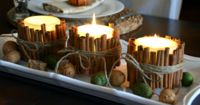 white candles wrapped with cinnamon sticks