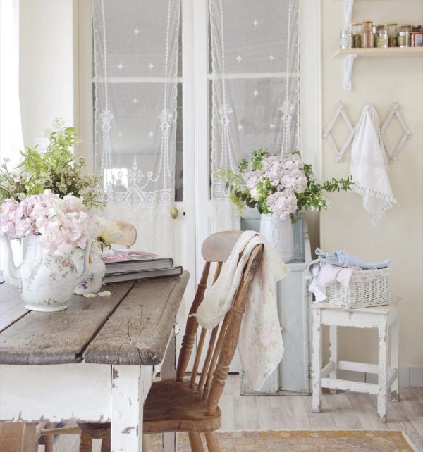 white dining room with fresh flowers in a white vase