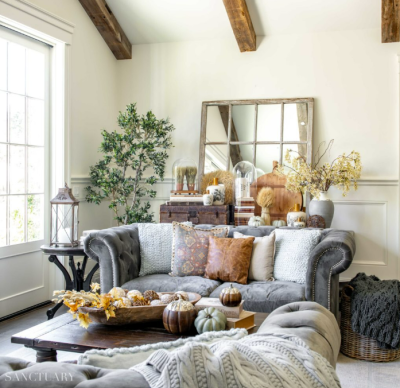 grey velvet sofa in white living room with fall decor
