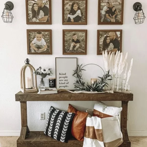 entryway with console table, pillows and family photos