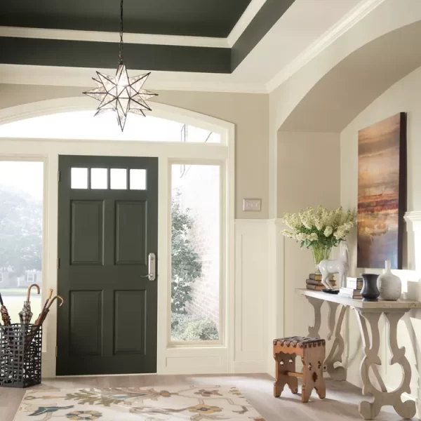 entryway with black door, black ceiling, umbrella stand, large rug and entryway table