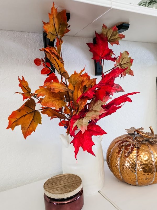 fall leaf branches in a white vase