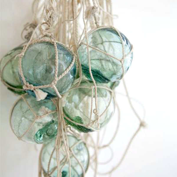 modern coastal vintage decor glass floats hanging in a net