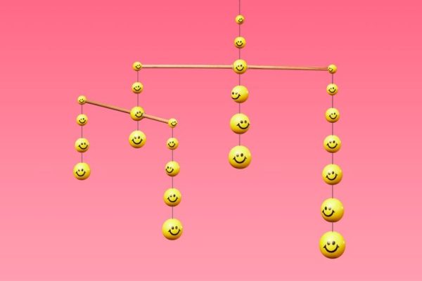 a mobile with yellow smiley face balls hanging from it