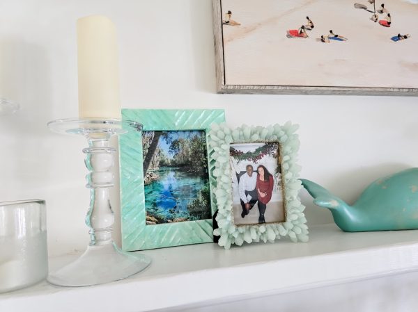 white fireplace mantel with seaglass green picture frames with vacation and family photos fireplace mantel summer decor