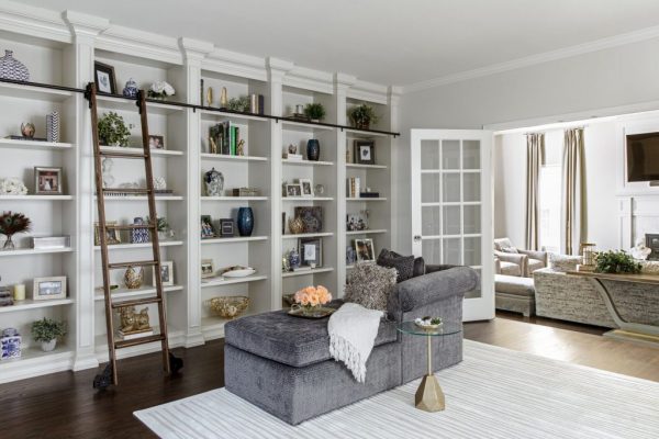 large wall shelving with a library ladder hiring an interior designer