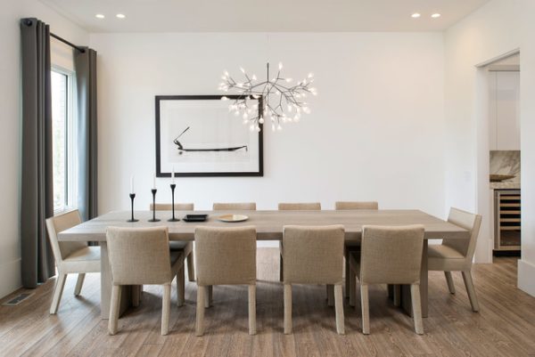 Minimalistic dining room with a large chandelier how to decorate with less