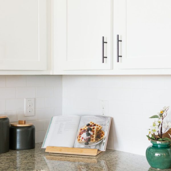 white kitchen countertop with an open book