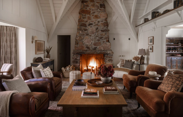 living room with large stone fireplace, leather chairs and velvet chairs top home decor trends for fall