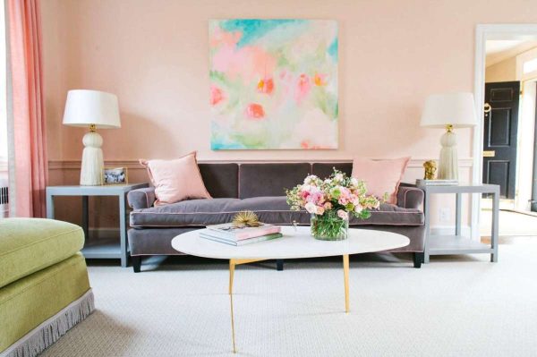 living room with pink walls and large art transition your living space from spring to summer