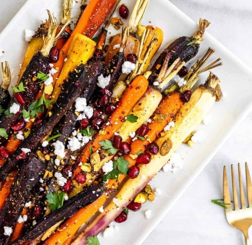 a white dish filled with maple glazed carrots