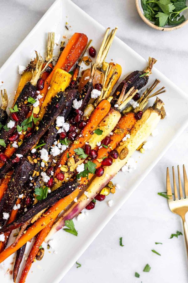 a white dish filled with maple glazed carrots