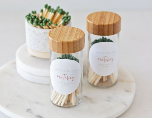 2 glass jars with wooden tops and matches inside