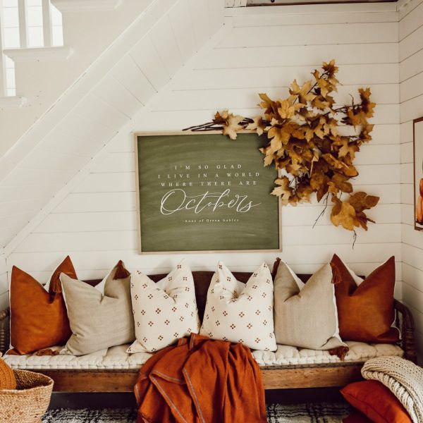 cozy nook under the stairs with fall pillows and blanket