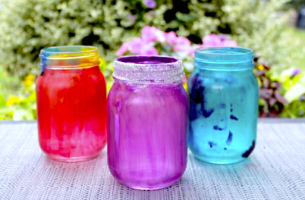 painted mason jars on a table fall decor using children's crafts