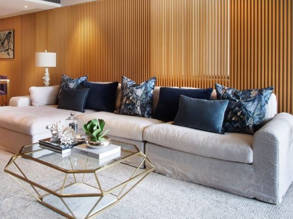 living room with glass coffee table and wood paneling designer secrets for a room that stays in style