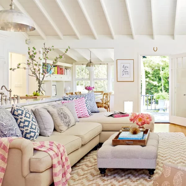 White living room with a sofa and colored pillows