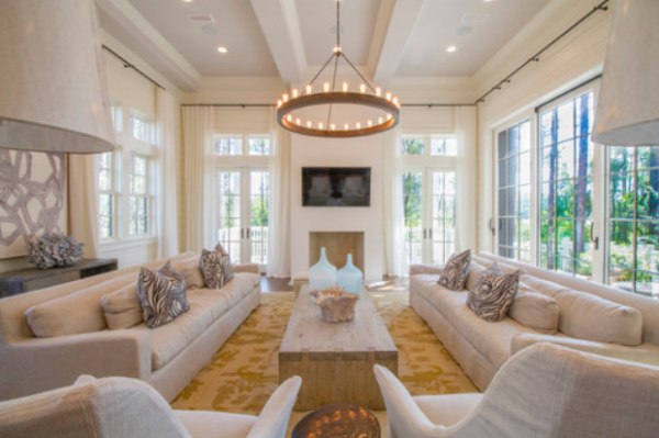 white living room with a large chandelier and a fireplace