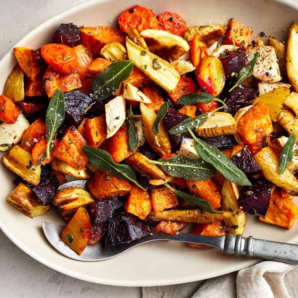 a white plate of roasted root vegetables