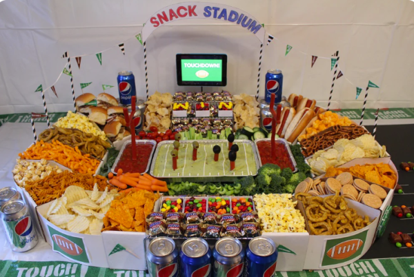 snacks on a table designed to look like a stadium host a game day party