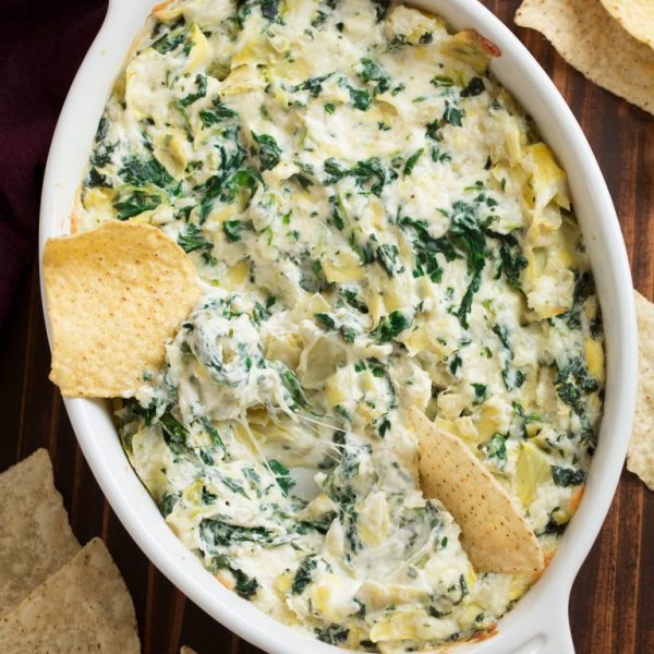 spinach artichoke in dish with tortilla chips