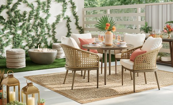 outdoor dining set with woven area rug and plants add more spring colors to your home.