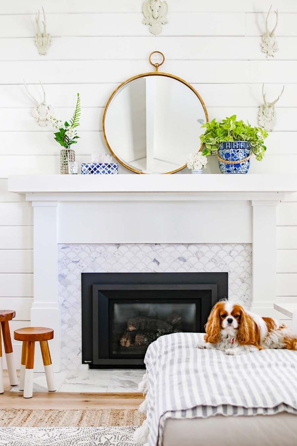 white fireplace with blue and white vases with greenery