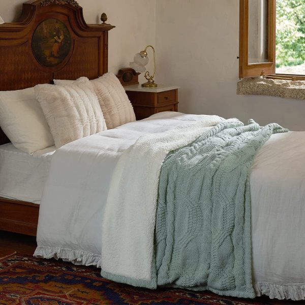 bed with white and green blankets