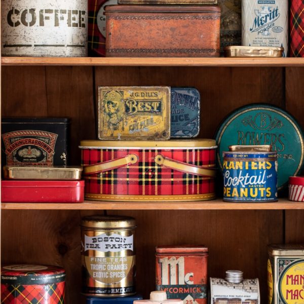 a collection of vintage tins on a shelf