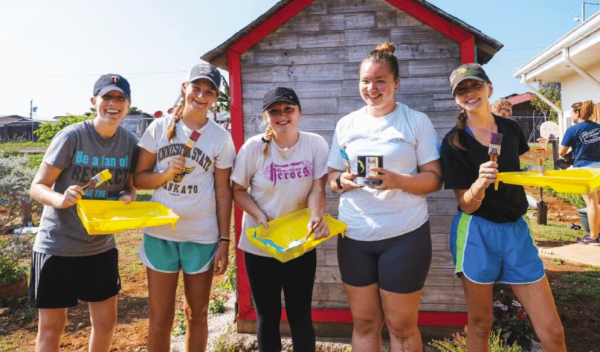 a group volunteering to paint buildings